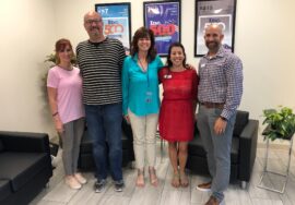 picture of five people in business casual dress in the e-TeleQuote Insurance lobby